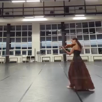 Film still of the dancing violinist performing in a studio