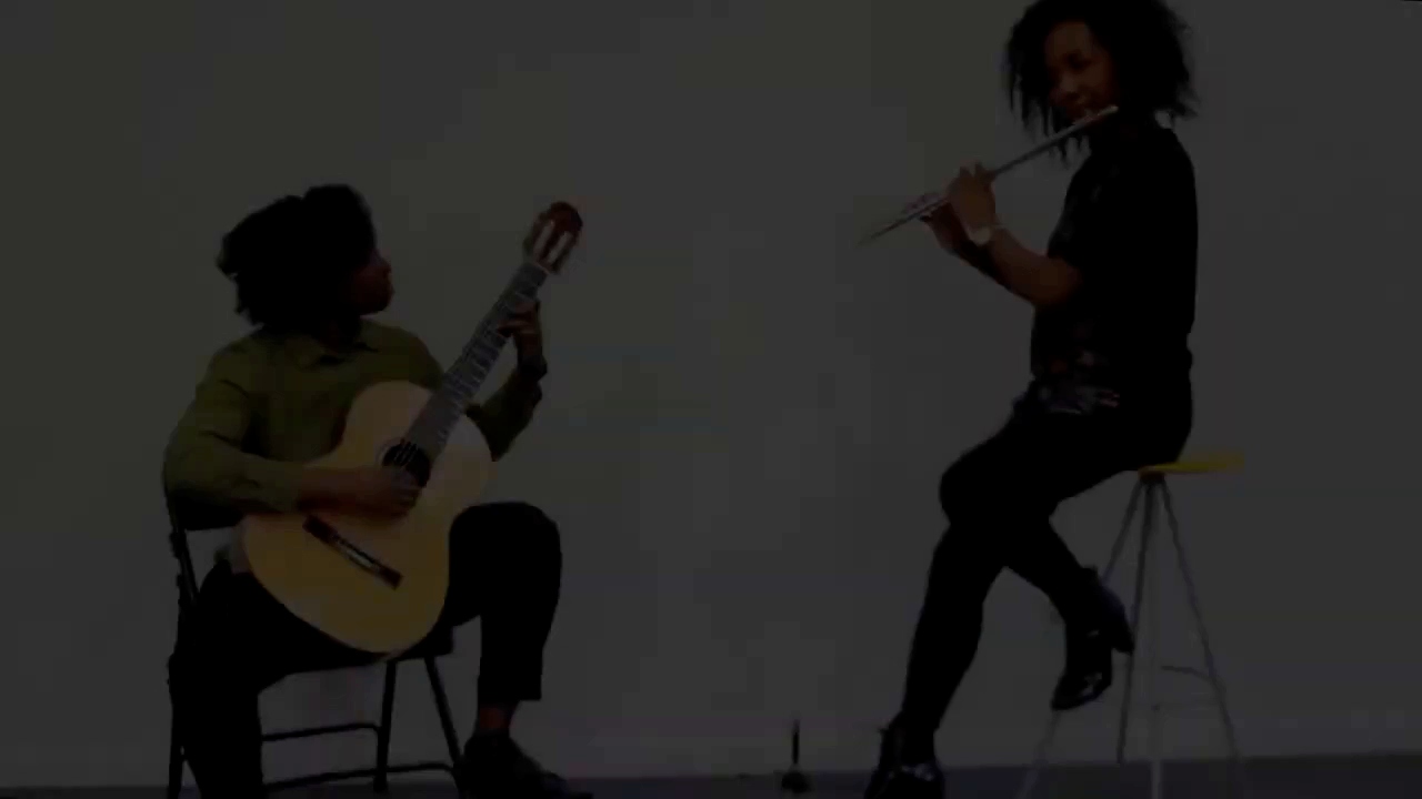 Film still of the flutist and guitarist performing together