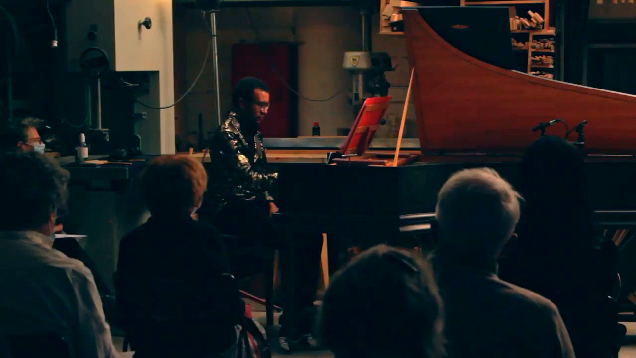 Film still of the harpsichordist in concert