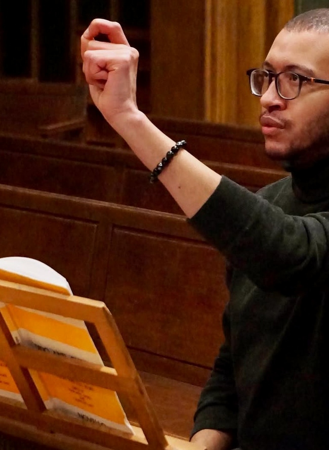 Harpsichordist performing in a historic setting