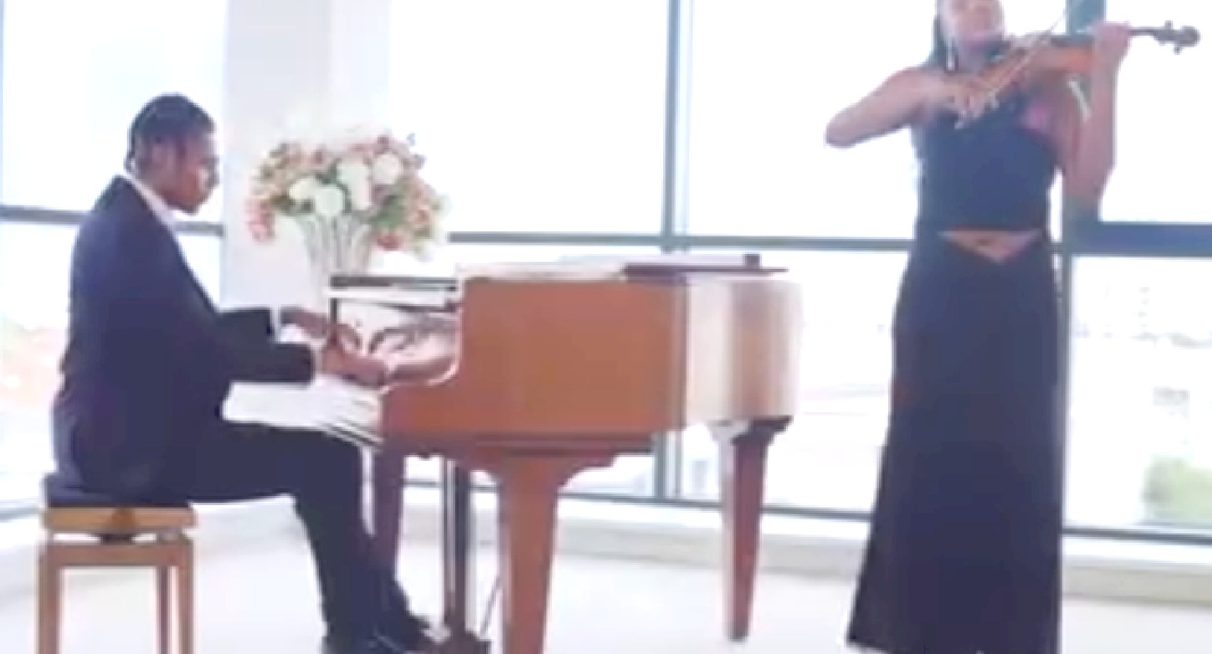 Film still of the violinist and pianist performing together